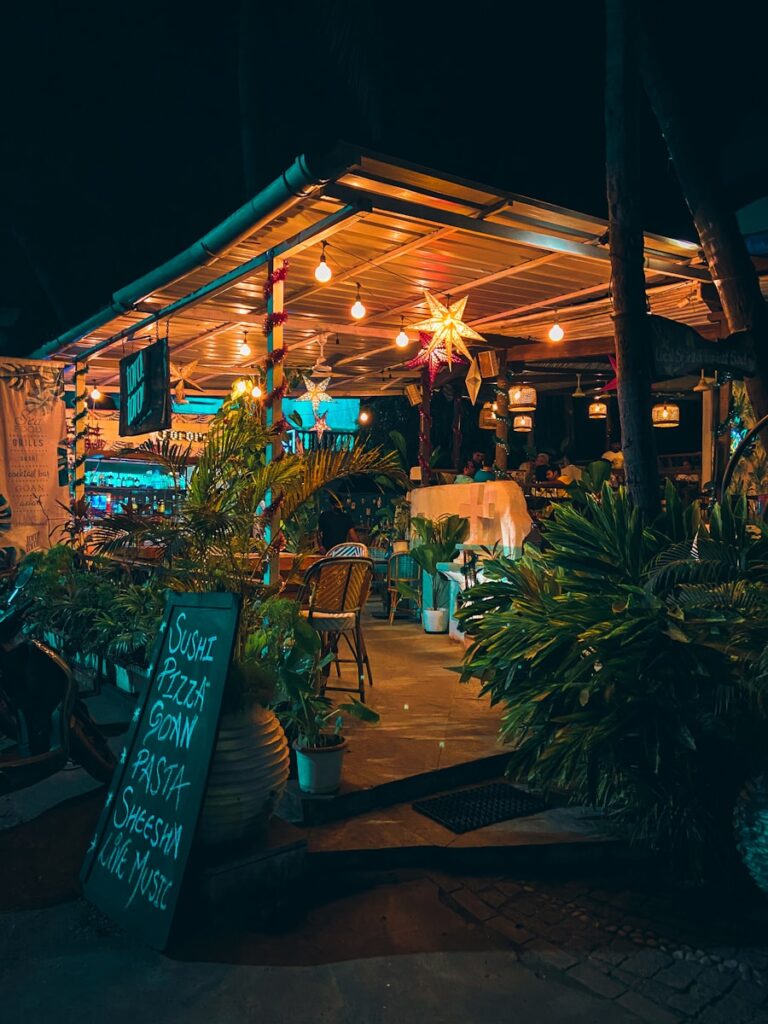 a restaurant with a lit up sign in front of it